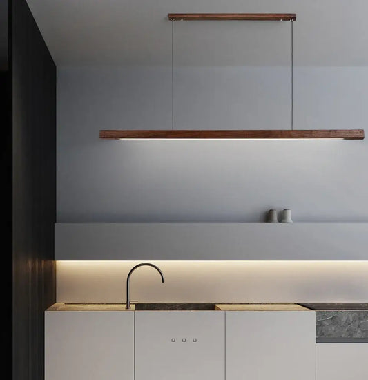 Nordic wood pendant lights in a modern kitchen, showcasing minimalist design and LED warmth from Housite.