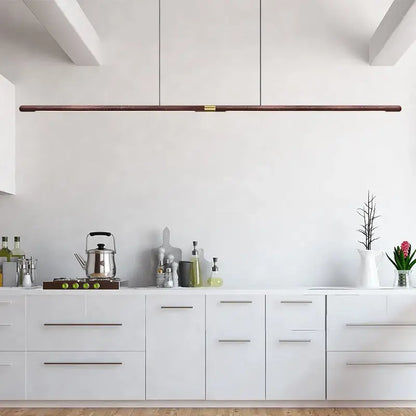 Luxury LED solid wood pendant light in a modern kitchen, showcasing Nordic black walnut design and energy-efficient lighting.