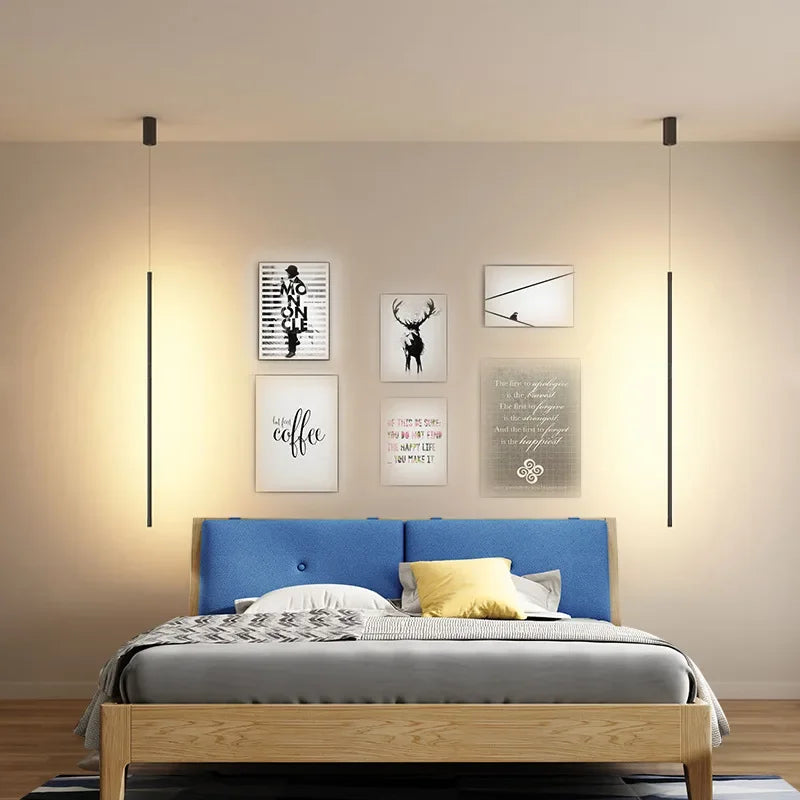 Nordic modern pendant lights illuminating a stylish bedroom with art on the walls and a cozy bed.