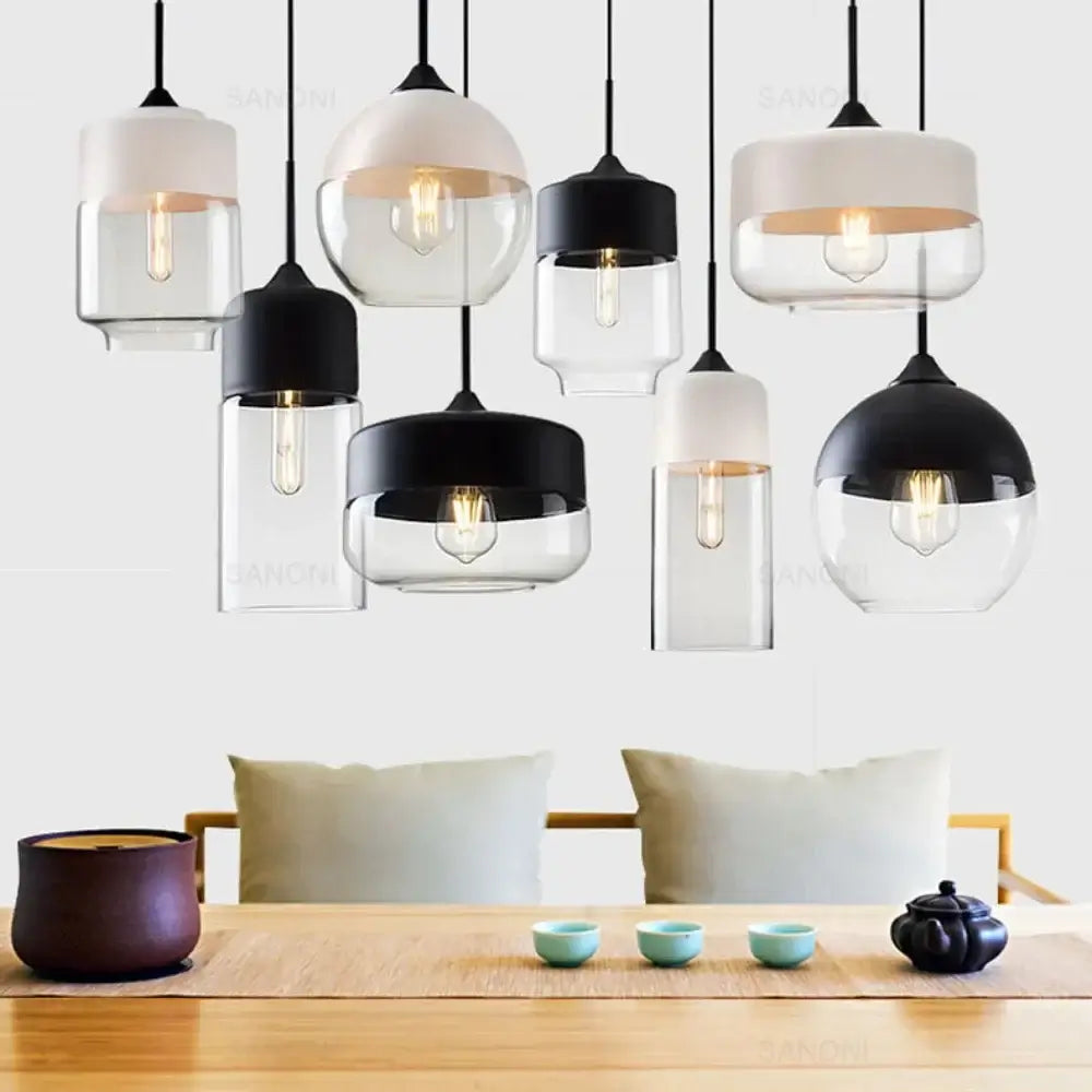 Modern Nordic LED glass pendant lights in various designs, enhancing a stylish dining area with cozy illumination.