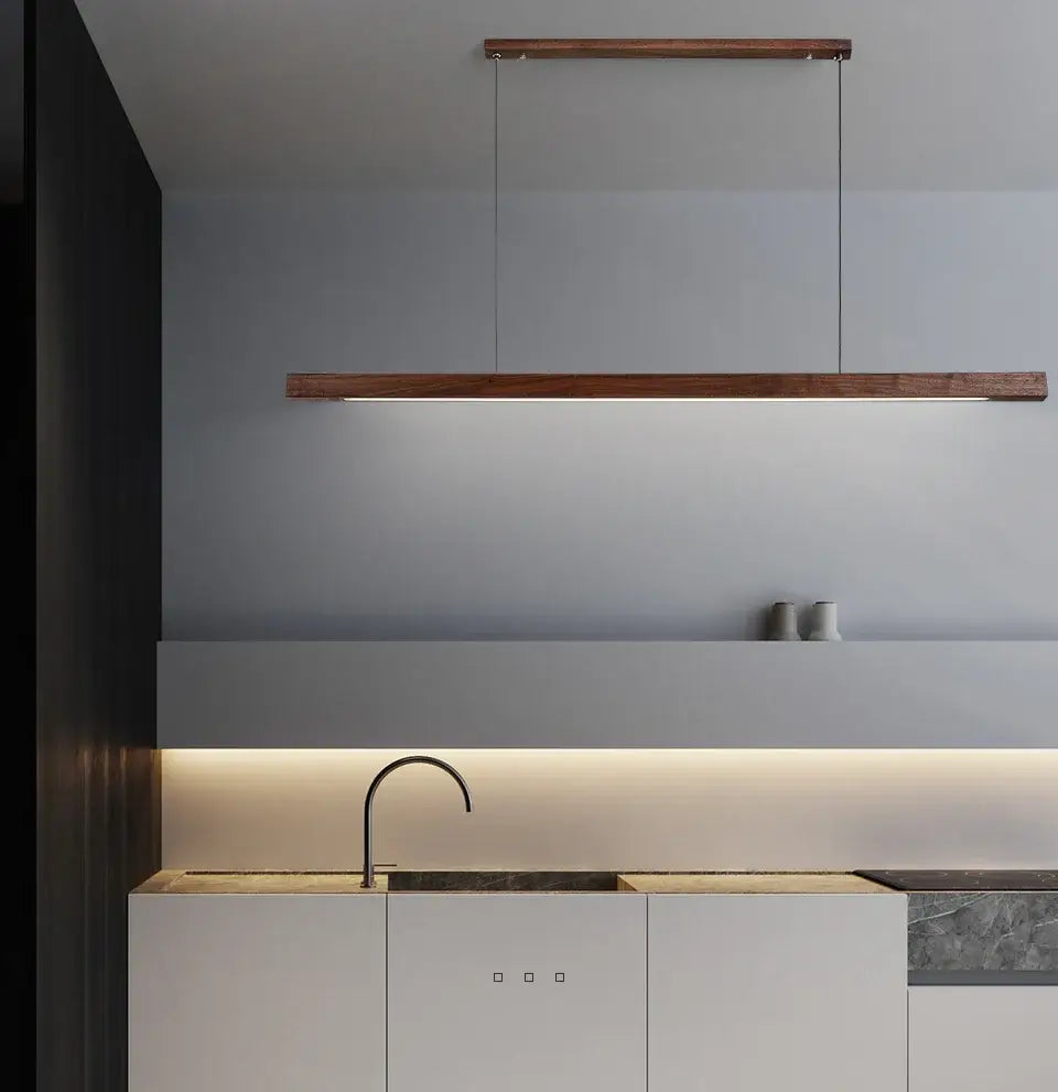 Nordic wood pendant light over a modern kitchen island with minimalistic design and elegant LED illumination.