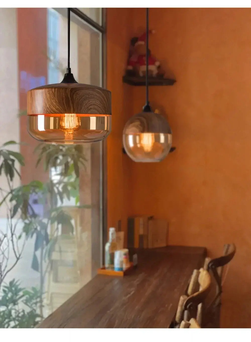 Nordic LED glass pendant lights with wooden accents hanging over a cozy dining table.