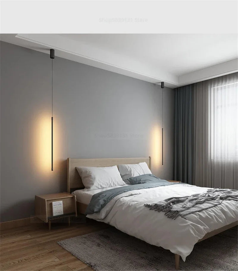 Nordic modern pendant lights illuminating a minimalist bedroom with a wooden bed and soft bedding.
