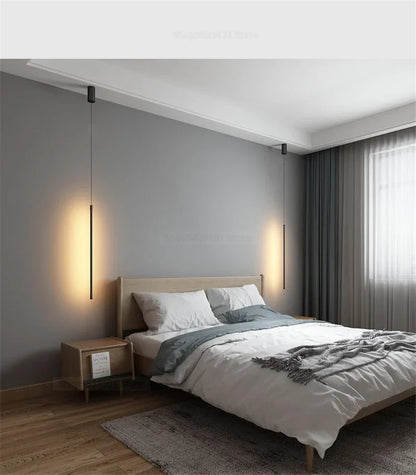 Nordic modern pendant lights illuminating a minimalist bedroom with a wooden bed and soft bedding.