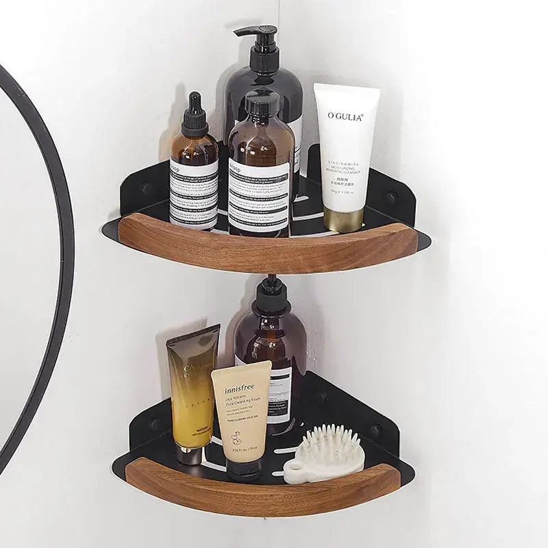 Black and white wall mounted bathroom shelves showcasing toiletries and beauty products in a stylish corner installation.