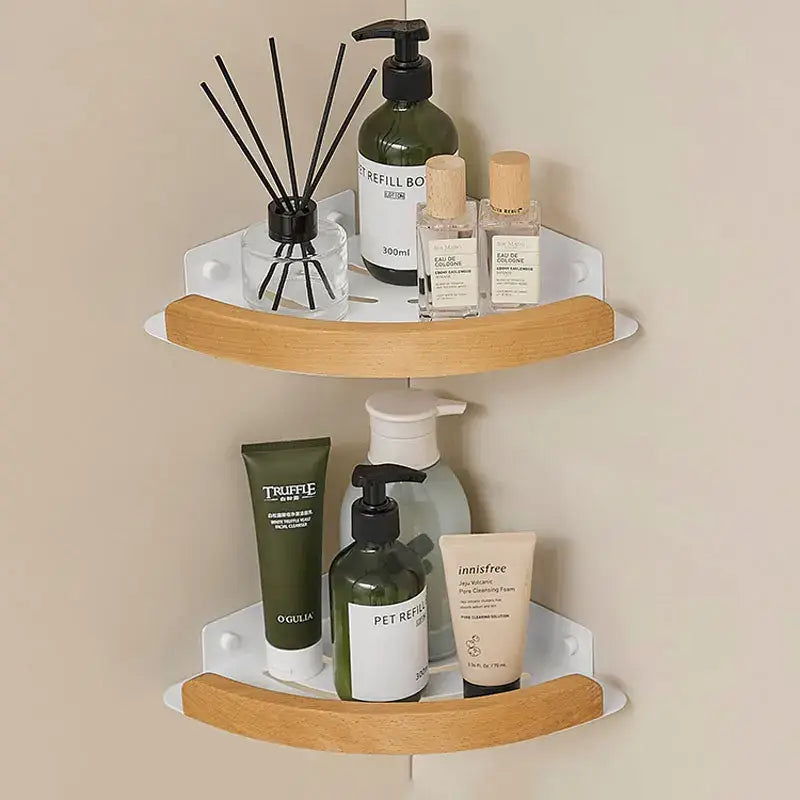 Black and white wall mounted bathroom shelves holding various beauty products and room fragrance.