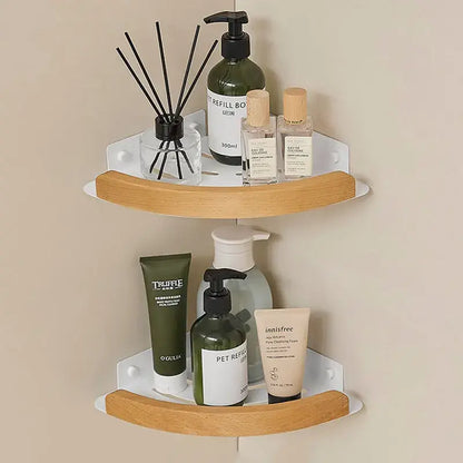 Black and white wall mounted bathroom shelves holding various beauty products and room fragrance.