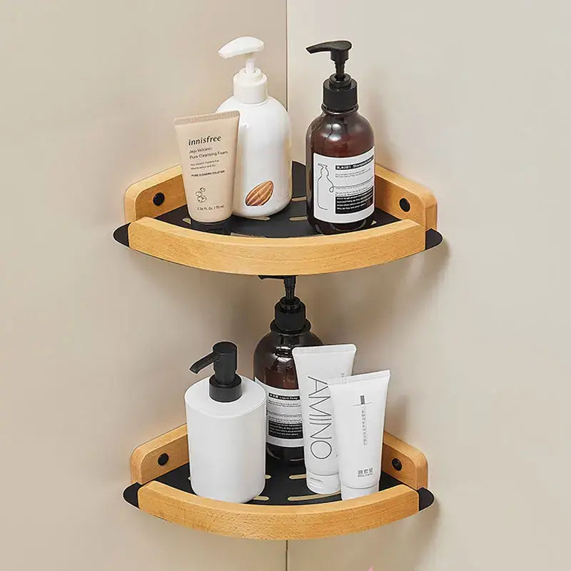 Black and white wall mounted bathroom shelves displaying various skincare products in a stylish corner arrangement.
