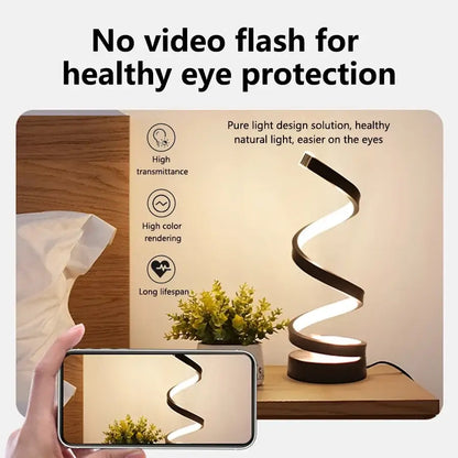 Dimmable spiral LED night light shown beside a phone, highlighting its modern design and eye protection features.