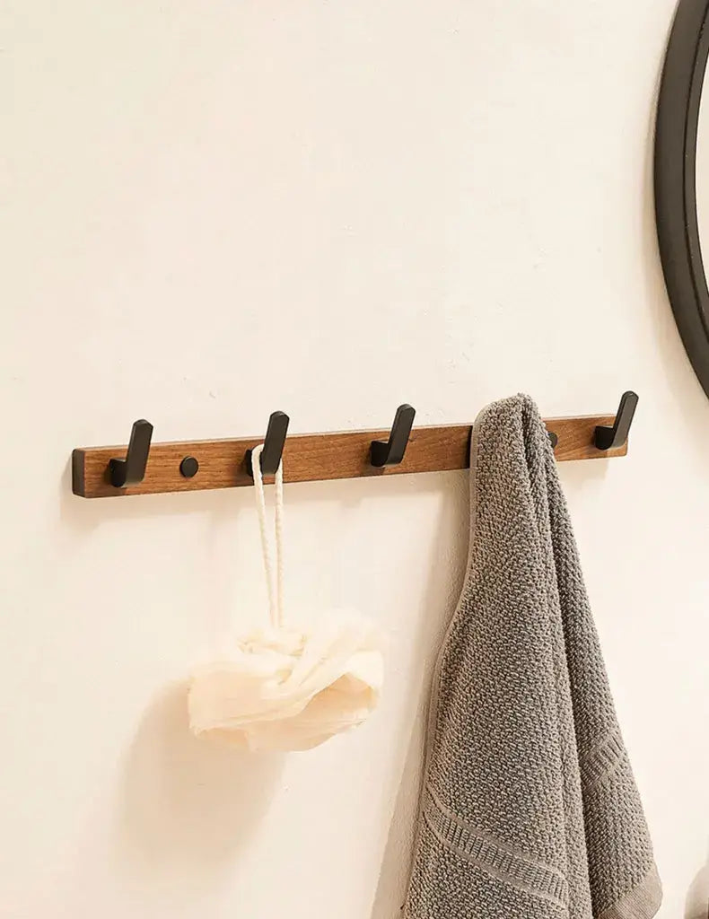 Wood Black Hook by Housite, a space-saving towel and clothes hook for modern bathrooms and living rooms.