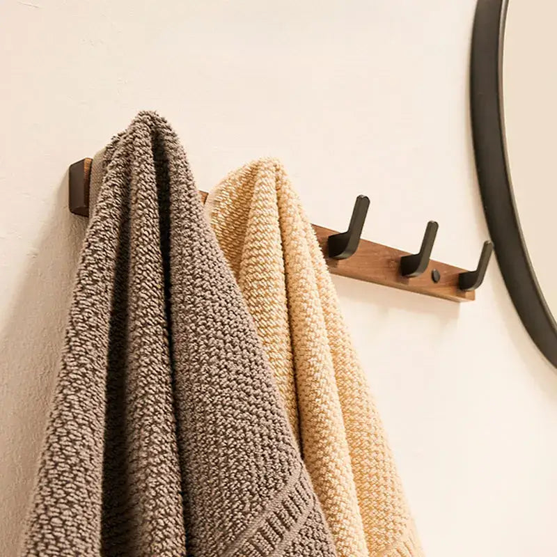 Wood Black Hook from Housite holding two towels, adding minimalist style to modern bathroom decor.
