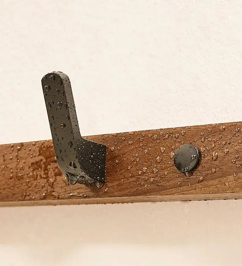 Wood black hook attached to a wooden surface, showcasing a sleek design and water-resistant features for versatile use.