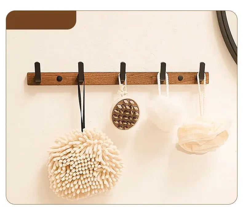 Housite Wood Black Hook displaying stylish bath accessories in a minimalist design on a wall.