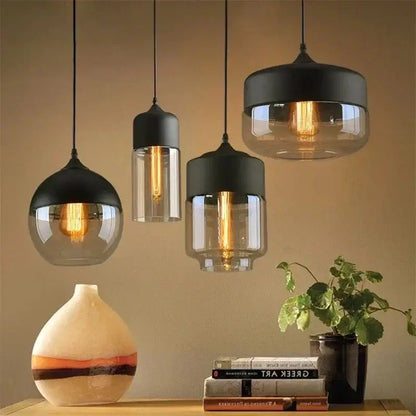 Nordic LED glass pendant lights in modern living space with a decorative vase and books.