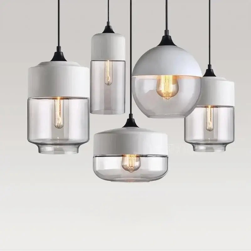 Modern Nordic LED glass pendant lights in various shapes hanging against a neutral background for stylish home decor.