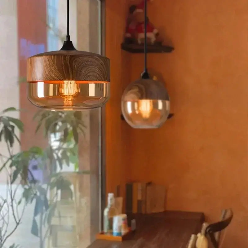 Nordic LED glass pendant lights with wood accents hanging in a cozy dining area.