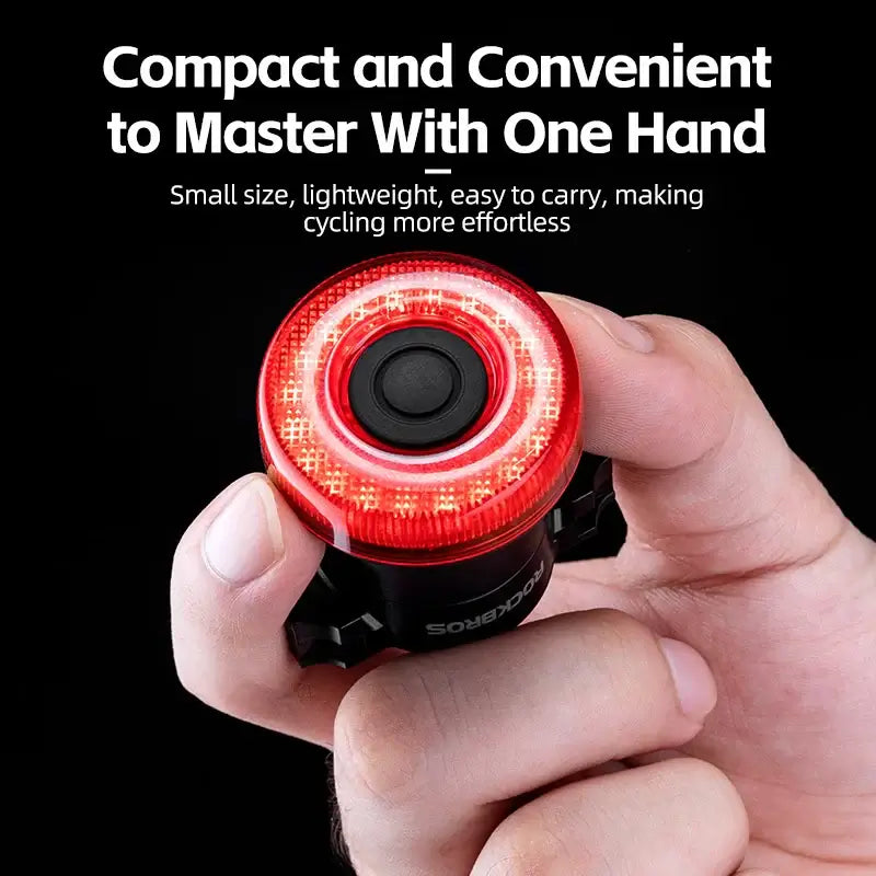 USB-C rechargeable bike tail light held in one hand, showcasing compact design for easy cycling.