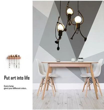 vintage industrial chandelier hanging above a minimalist dining table with modern chairs and artistic wall design